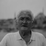 Artistic monochrome portrait of an elderly man with a serene expression, taken outdoors in Istanbul.